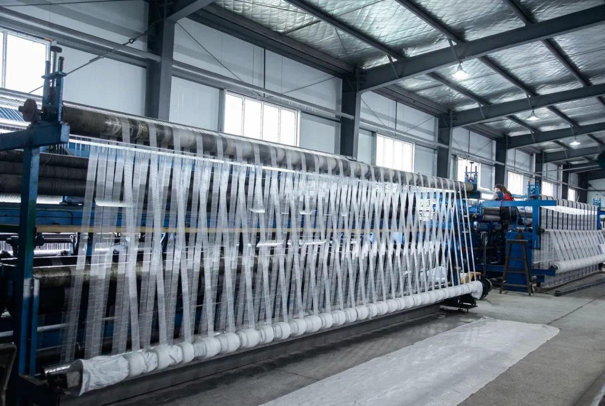 Rows of knot netting machines producing white nylon net